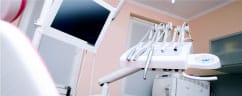Modern dental treatment room with professional equipment and overhead light fixture