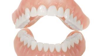 Pair of dentures shown from front and back views displaying full set of artificial teeth.