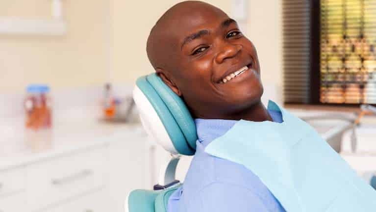 Smiling patient relaxing in dental chair at Groves Dental Care office